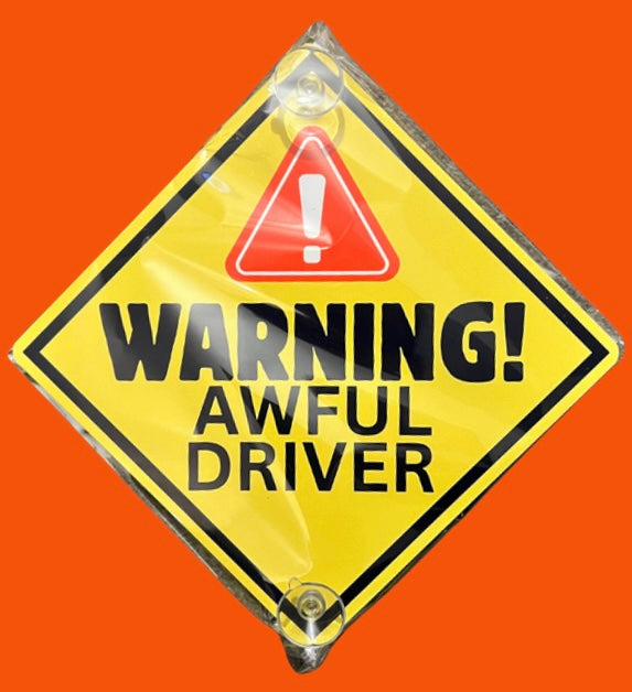 Yellow aluminium car window sign stating 'Warning! Awful Driver' with red alert icon. Durable and humorous vehicle decal for added road visibility.
