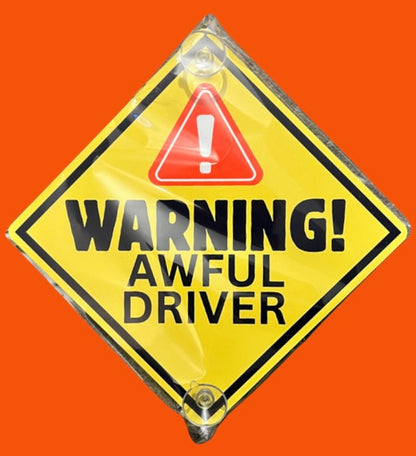 Yellow aluminium car window sign stating 'Warning! Awful Driver' with red alert icon. Durable and humorous vehicle decal for added road visibility.