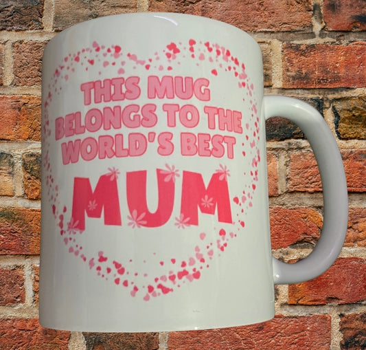 World's Best Mum Mug Gift with pink heart design and bold text on white 11oz ceramic. Ideal for daily coffee, microwave and dishwasher safe.